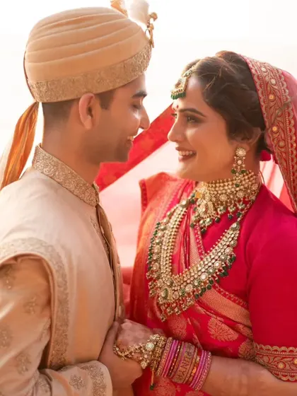 A beautiful moment between the bride and groom. Her makeup is soft and romantic, allowing her natural happiness to be the focus.