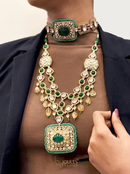 One celebration, many layers of shine. This look demonstrates the art of layering, with a bold emerald choker paired with a longer, cascading polki and emerald necklace for a truly regal effect.