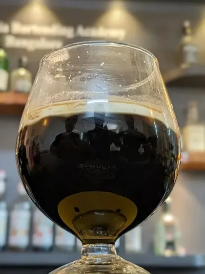 A close-up of a dark, stout-like cocktail, showing our range from light and fruity to rich and complex drinks.
