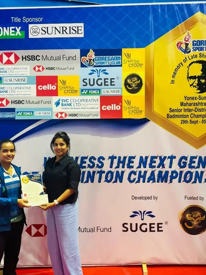 A semi-finalist from the women's category being awarded her certificate, celebrating the high level of competition at the event.