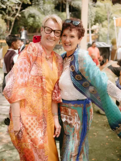 Two guests in colorful attire share a happy moment at a Haldi ceremony. This photo captures the joyful and relaxed atmosphere I aim to create for everyone attending.