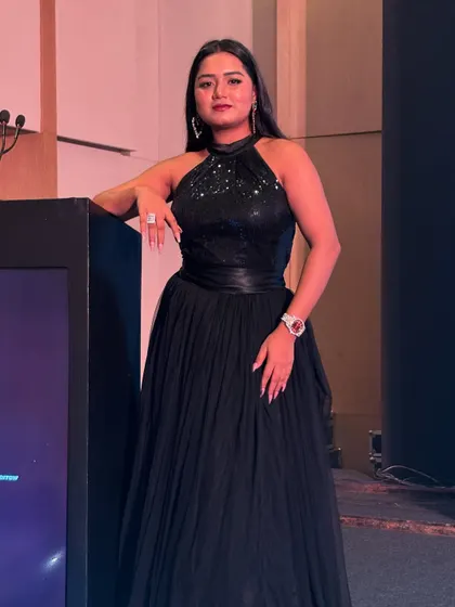 A full-length shot in a classic black gown for a V-Guard corporate evening. Black is power, and it's the perfect choice for a formal, high-stakes event.
