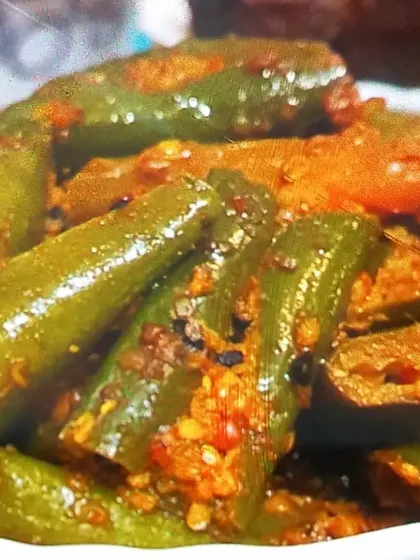 A close-up of my Green Chilli Pickle, glistening with oil and spices. You can almost taste the spicy and tangy flavor just by looking at it.