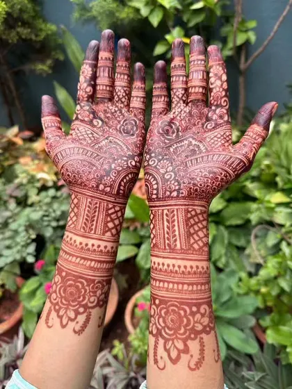 A fully developed stain on both hands, extending up the wrists. The natural lighting shows the true maroon-brown tones of the organic henna.