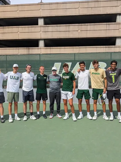 A photo of the University of Alabama at Birmingham (UAB) men's tennis team with Coach Nelson. This shows his direct involvement with a competitive US college team, bringing that experience directly to our athletes.