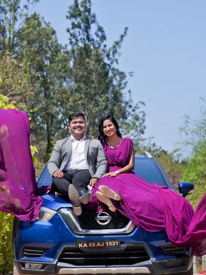 We love getting creative with props. Here, the bride's long, flowing purple dress creates a stunning visual as the couple poses on their car for this outdoor pre-wedding shoot.