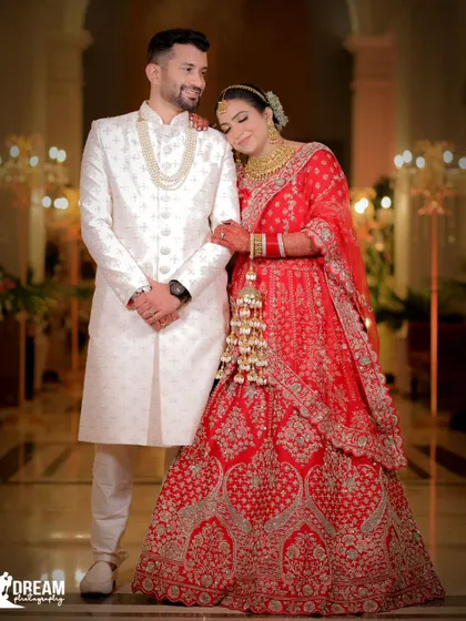 A classic wedding portrait of Ahana and Bhuvnesh, looking regal and happy in their traditional attire.