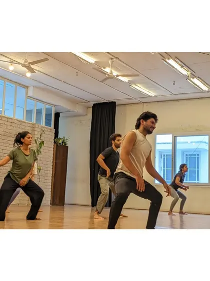 A group of students practices a synchronized movement sequence, building coordination and teamwork.