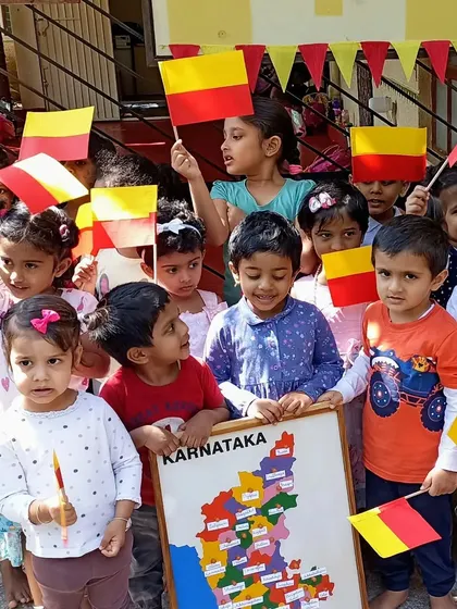 Children celebrating Kannada Rajyotsava, proudly holding the Karnataka flag.