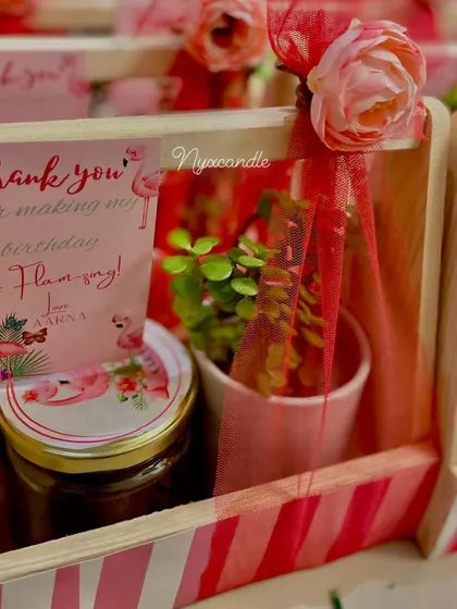 A close-up of the flamingo hamper, showing the custom "Flam-azing" thank you card and personalized jar lid.
