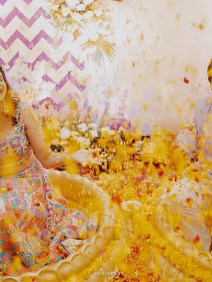 The best moments are the unscripted ones. This photo captures the pure joy of a couple's Haldi, surrounded by flowers and laughter. My job is to create the perfect setting for these memories to unfold.
