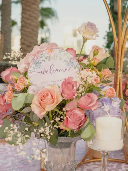 Every detail whispers romance. The welcome cards and floral centerpieces for the Bridgerton Mehendi were designed to be straight out of a Jane Austen novel.
