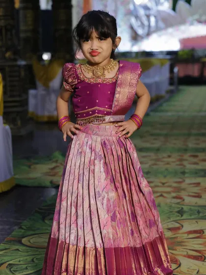 This little one is ready for the party! Her custom Pattu Pavadai is just too cute, and she's striking a pose like a true fashionista.