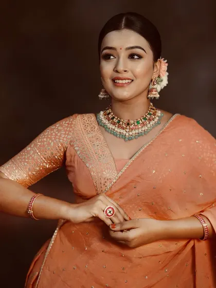 A happy and confident smile from a model wearing one of our rental lehengas during a portfolio shoot.