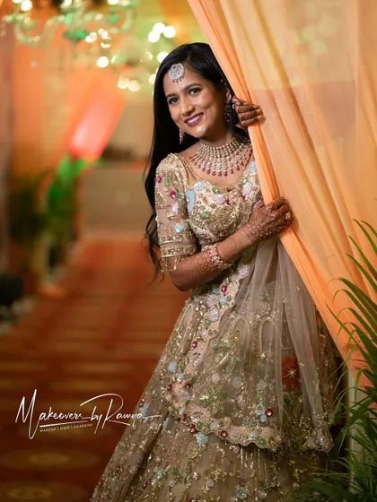 Jagruthi looking playful and radiant, peeking out from behind a curtain.