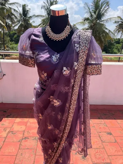 A closer look at the silver and sequin embroidery on the purple saree.