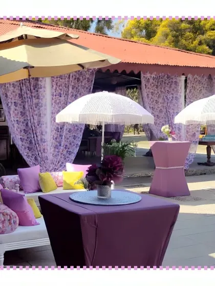 A chic outdoor lounge area at a Jim Corbett wedding, featuring purple decor and comfortable seating for guests to relax.