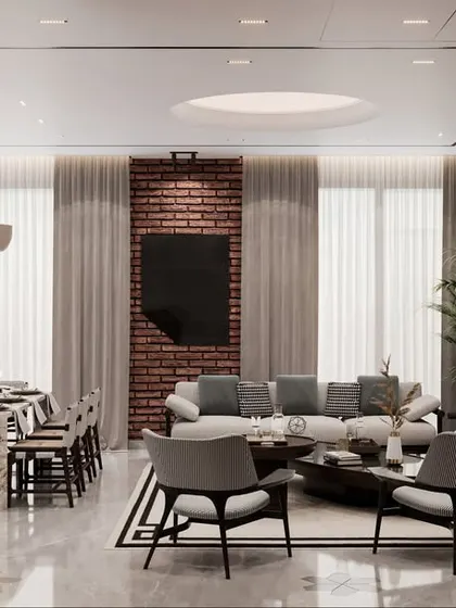 A render of a living and dining space designed with a chic and cozy atmosphere. The design features sleek furniture, a neutral color palette, and an exposed brick wall for a touch of rustic charm.