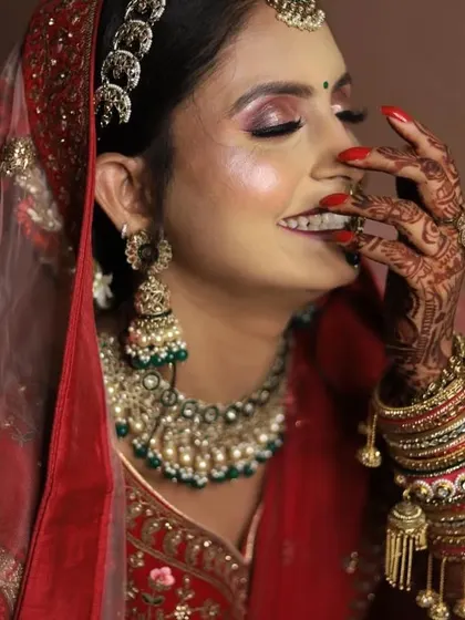A candid, happy moment of a bride, showing off her shimmery eye makeup.