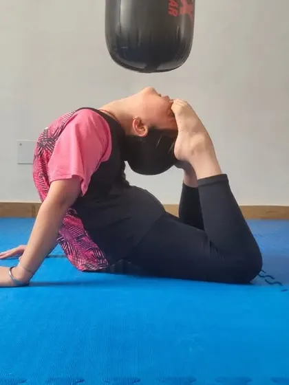 A young student demonstrates impressive flexibility, a key component of our training program. Flexibility helps in executing high kicks and preventing injuries.
