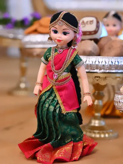 A close-up of a custom-dressed doll used in my seer plate decorations. These dolls add a unique and personal touch to the offering plates.