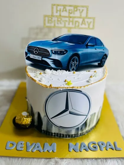 A sleek Mercedes-Benz themed cake for a car enthusiast, featuring the iconic logo and a picture of the E-Class model.