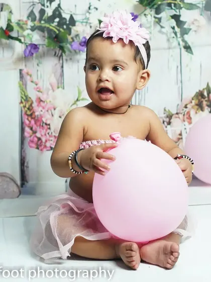 A simple and happy moment from a pre-birthday studio shoot. Sometimes all you need is a pink balloon to get the most joyful smiles.