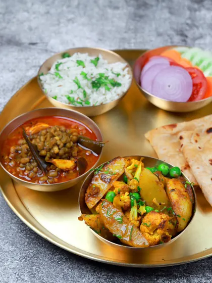 Some days, cooking isn't an option. This inviting plate of aloo gobi, whole masoor dal, rice, roti, and salad is the perfect solution for a busy day.