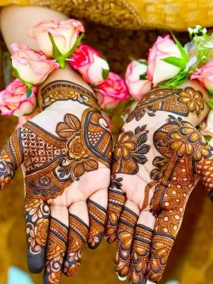 A beautiful floral mehandi design, accessorized with fresh roses. The henna stain is a lovely deep brown, showing the quality of the paste.