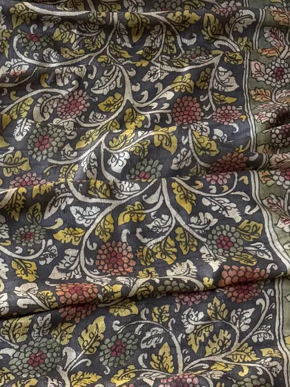 A close-up of the all-over floral jaal pattern on the silk dupatta. The use of muted red, yellow, and green vegetable dyes creates a sophisticated and earthy palette.