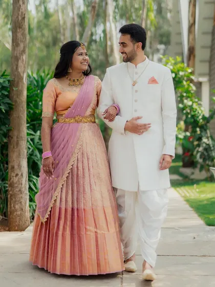 A classic portrait of a couple walking together in their beautiful traditional outfits. We capture these moments to create timeless images you'll cherish forever.