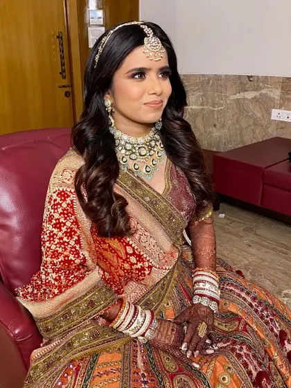 A beautiful candid shot of the bride Twinkle. Her makeup looks fresh and flawless, ensuring she feels comfortable and confident throughout her big day.