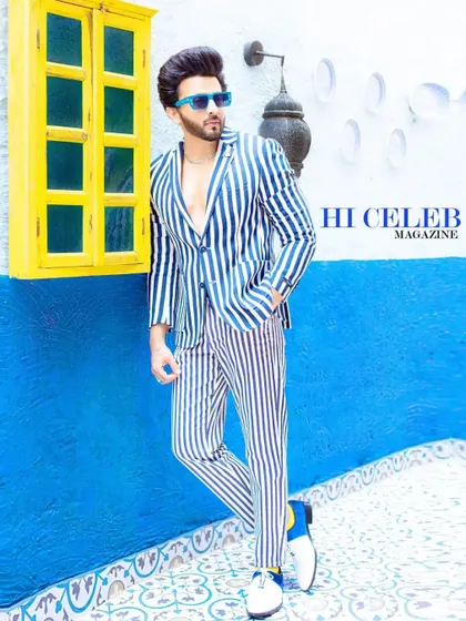 Another look from the Hi Celeb shoot with Dheeraj Dhoopar. This bold, striped suit against a vibrant blue and white backdrop creates a playful, summery, and high-fashion image, perfect for a style feature.