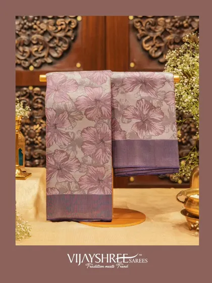 A floral woven Kanjivaram in shades of lavender and grey, offering a subtle and sophisticated take on floral patterns.