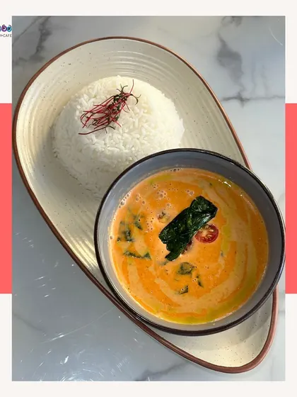 A comforting bowl of Thai curry served with steamed rice, beautifully plated and full of flavor.