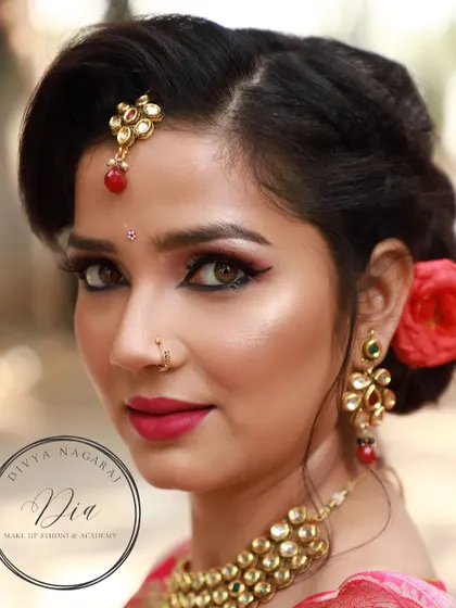 A soft and shimmering look from a creative shoot. This close-up highlights the sharp winged eyeliner, glowing highlighter, and pink lip, creating a look that is both glamorous and romantic.