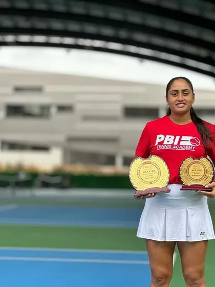 Akanksha Nitture with her Doubles Winner and Singles Runner-Up trophies from the AITA 1 lakh tournament in Bangalore, showcasing a week of exceptional performance.