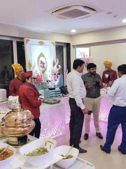 Our staff are always available to assist guests and answer questions about the menu. Here, our team members interact with guests at a buffet counter.