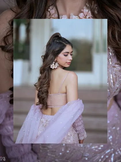 A lovely shot of the bride from the back, highlighting her elegant hairstyle and gown.