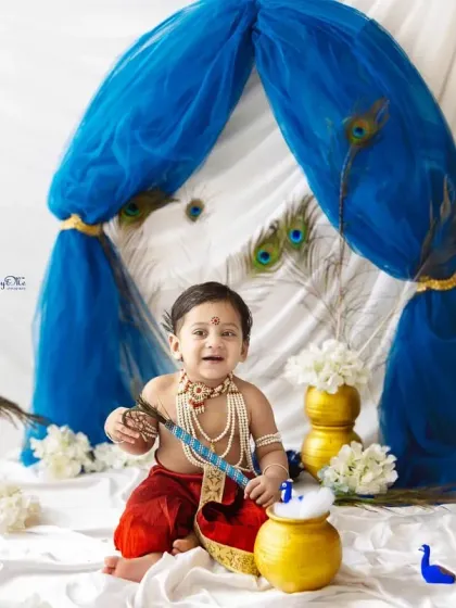 A big, happy smile from our little Krishna. The joy of the festival is perfectly captured in his bright expression.