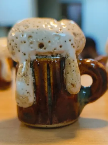 Another angle of the miniature beer mug, highlighting the glossy finish and the incredible texture of the "foam."