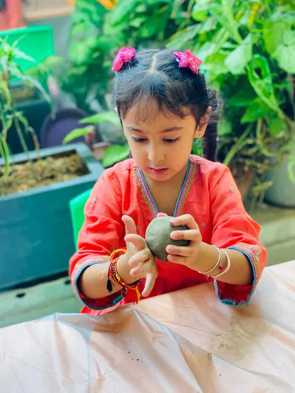 A beautiful shot of a young girl in traditional attire working on her clay idol. Our festive workshops are a great opportunity to celebrate and create in style.