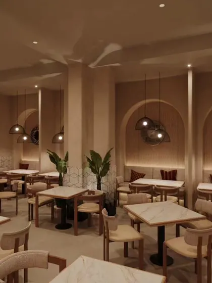 A modern and elegant restaurant interior defined by soft, neutral tones, arched wall niches, and minimalist pendant lighting. The clean lines and uncluttered space planning create a sophisticated and calm dining experience.