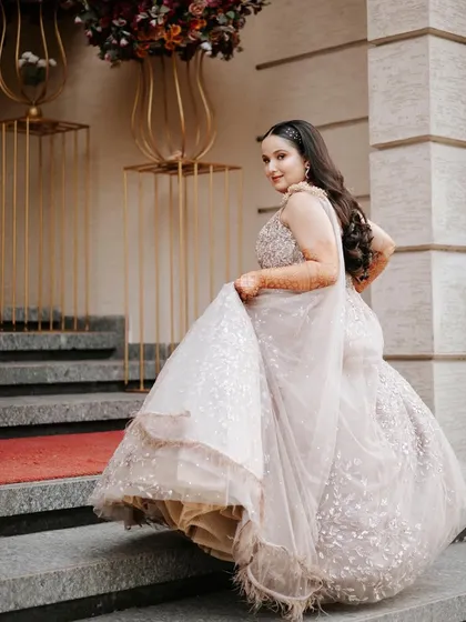 A beautiful shot of the bride walking up the stairs, looking back with a smile. This captures a candid, in-between moment with elegance.