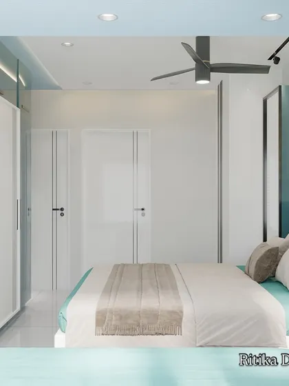 Another angle of the teal bedroom, this view showcases the floor-to-ceiling white wardrobes that provide extensive storage. The clean lines and simple hardware contribute to the room's modern and uncluttered feel.