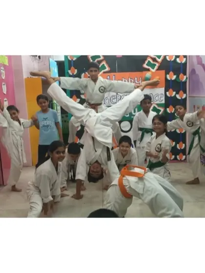 A dynamic group pose showing a variety of skills, from handstands to high kicks, all part of our fun and engaging training for kids.