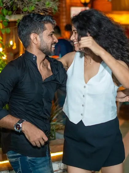 A candid shot of two dancers sharing a smile and a great connection. This is the heart of social dancing.
