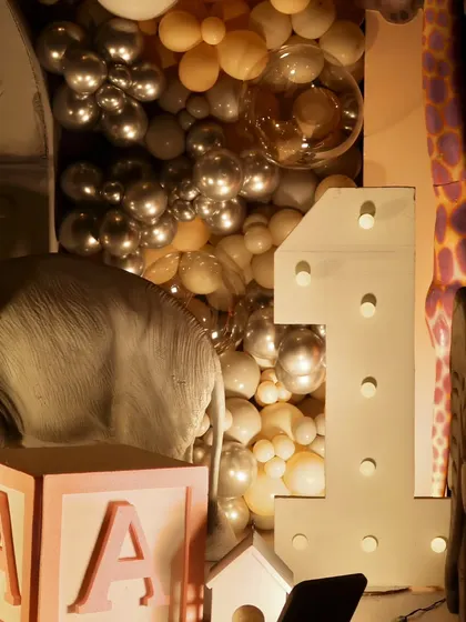 A light-up number '1' and a personalized 'A' block are part of the detailed decor for this special first birthday celebration.