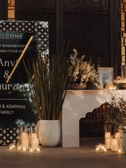 A detailed shot of the welcome area, where an ornamental mirror signage and candlelit arrangements greeted guests, hinting at the royal theme waiting inside.