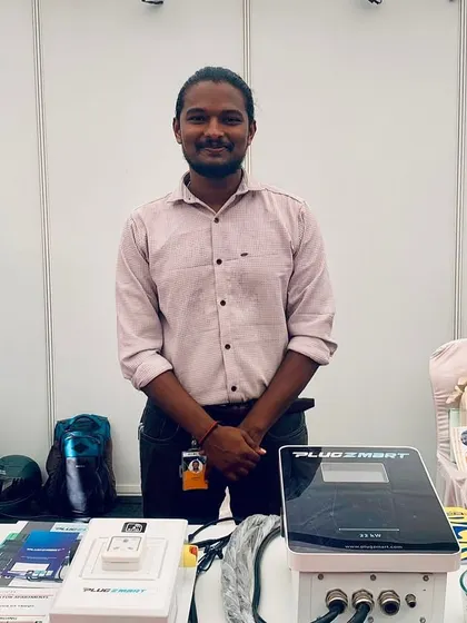 Another member of our technical team at our booth, standing by the equipment we use for our installations. We are always prepared to answer detailed questions about our products, like the Plug N Smart chargers shown here.